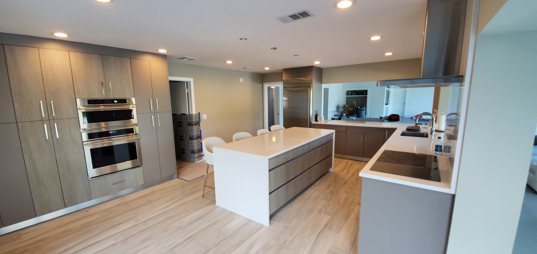 Remodeled Kitchen in Boca Raton with Modern cabinets, waterfall island, and built in double oven