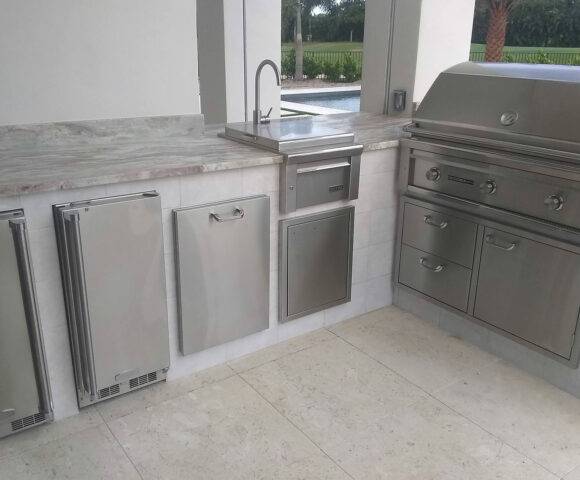 a counter featuring a sink and other appliances for Outdoor Kitchens in Lake Worth, Boca Raton, Boynton Beach, Delray Beach