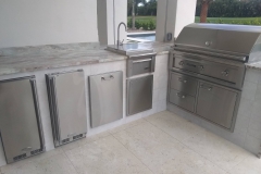 Outdoor kitchen sink and grill in Boca Raton backyard